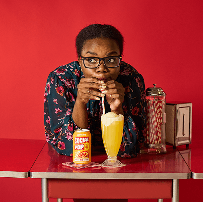 A person drinking Social Pop with a straw