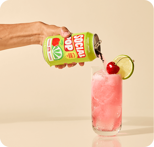 Cherry Limeade Hard Soda being poured from a can into a glass