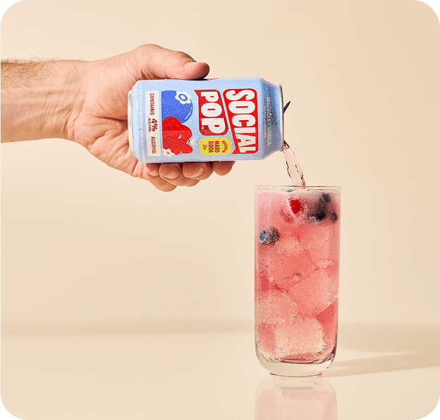 Wildberry Vanilla Hard Soda being poured from a can into a glass