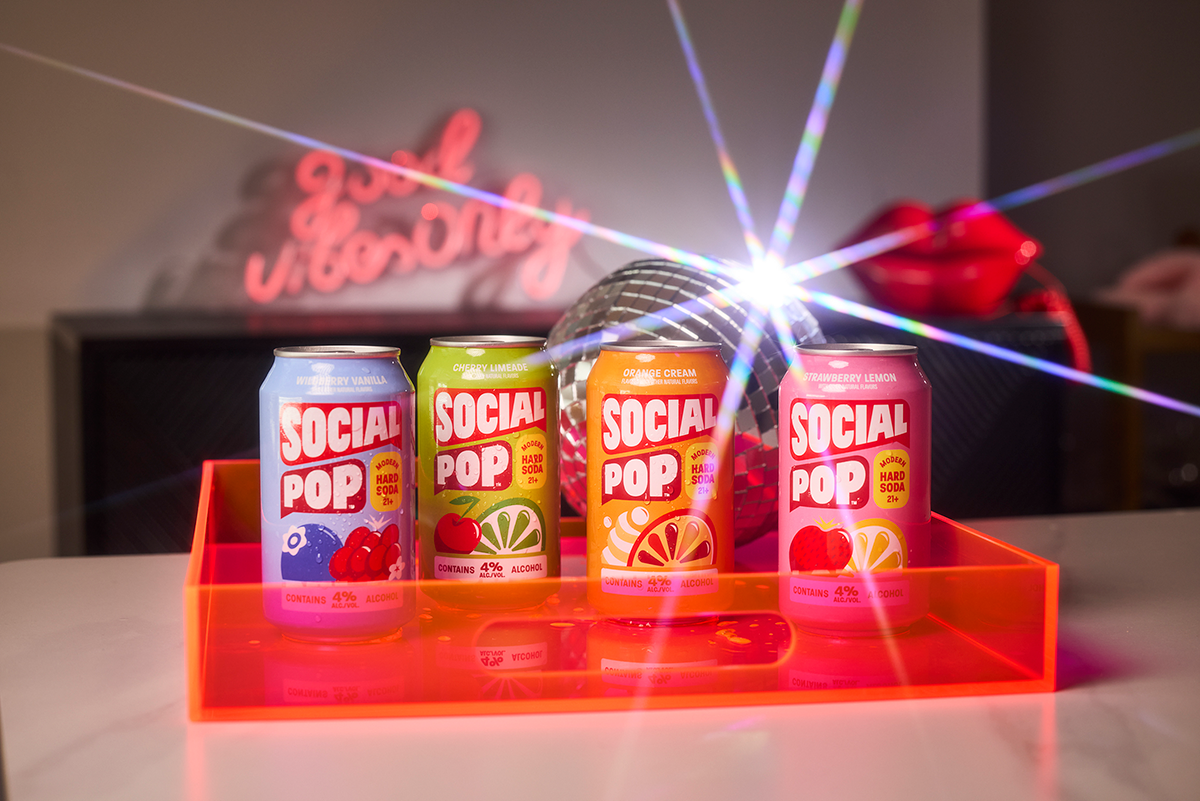 The Social Pop lineup of cans with a shining disco ball.
